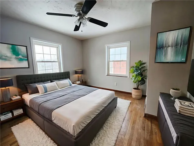 a bedroom with bed and a potted plant