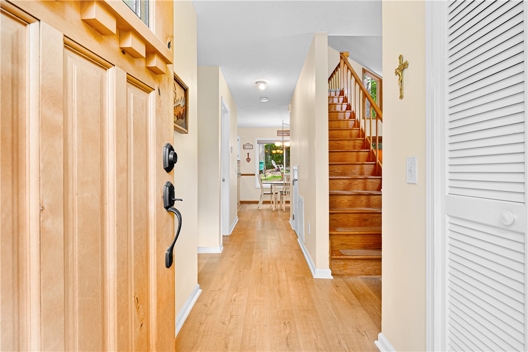139 Tulip Lane Westminster, SC 29693 - Photo 23 of 37 A welcoming entryway with natural hardwood flooring and a wooden staircase ascending to upper levels.