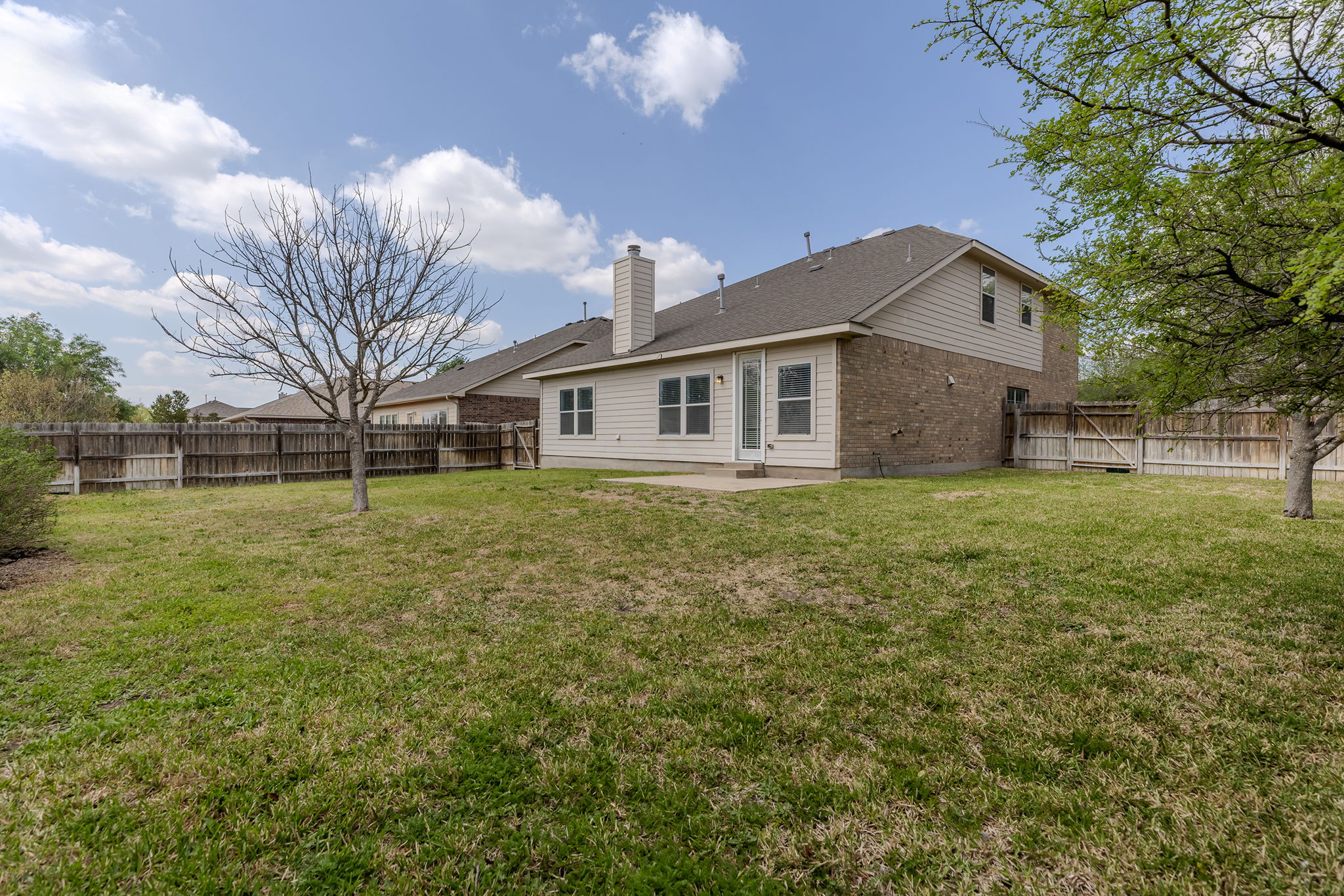 3013 Hawks Swoop Trail Pflugerville, TX 78660 - Photo 37 of 38 Rear view of property featuring brick siding, a patio, a fenced backyard, and a chimney