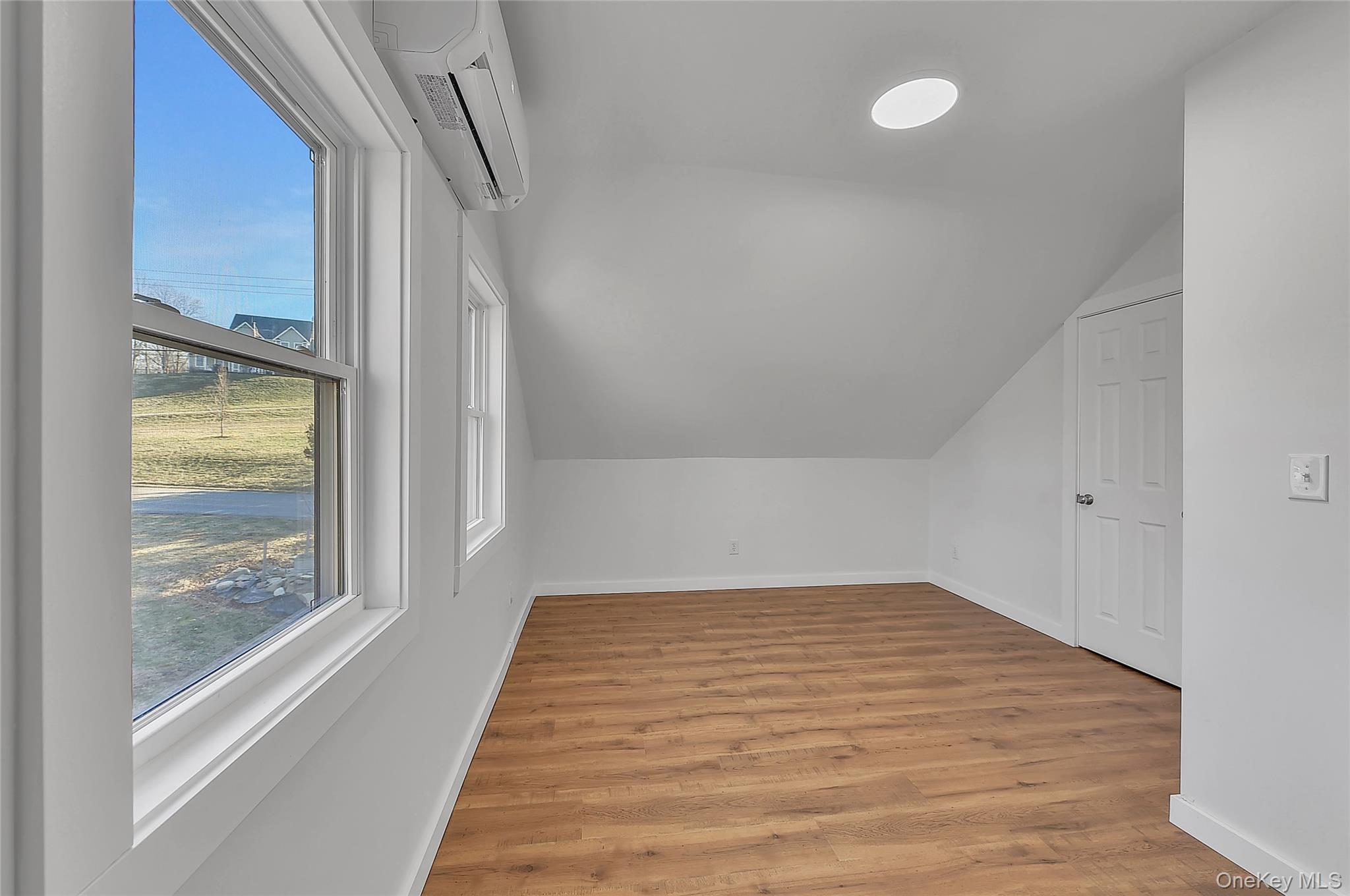 67 Jacobs Road Westtown, NY 10998 - Photo 25 of 36 Additional living space featuring a wall mounted air conditioner, light wood-type flooring, and vaulted ceiling