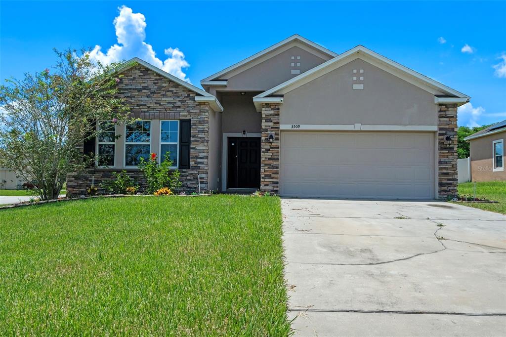 a front view of a house with a yard and garage