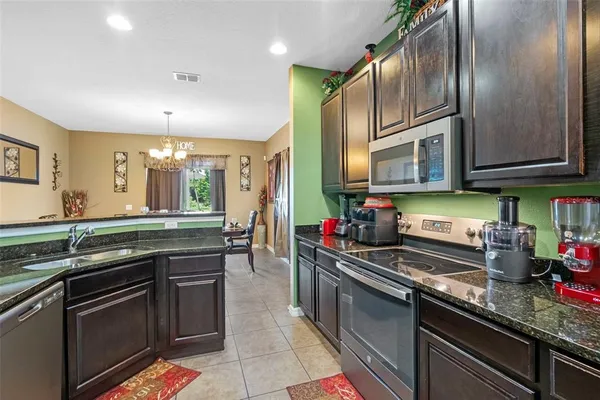 a kitchen with stainless steel appliances granite countertop a sink and stove