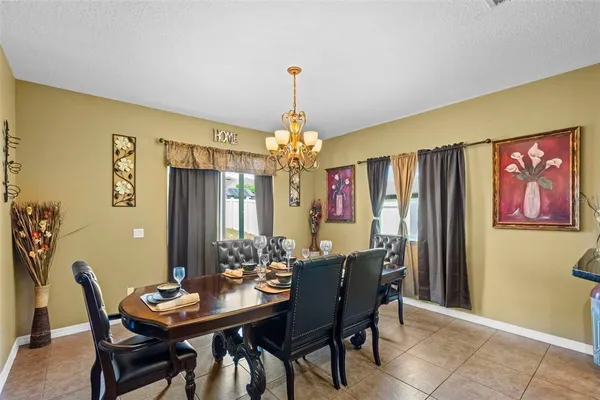 a view of a dining room with furniture and chandelier