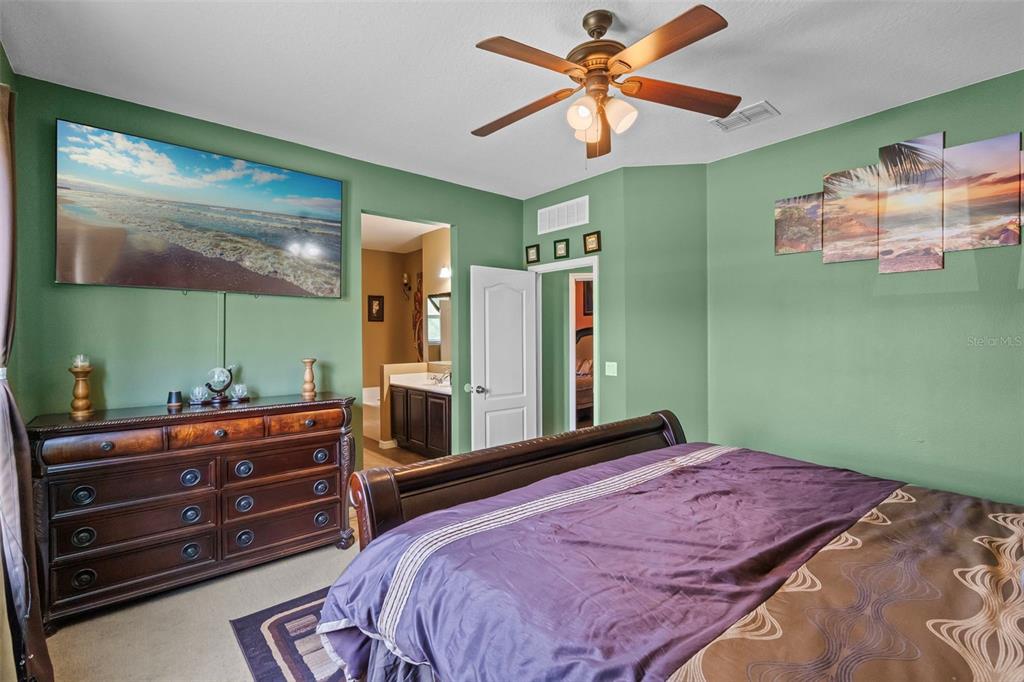 3509 Spring Creek Road Dundee, FL 33838 - Photo 17 of 32 a bedroom with a bed and a dresser