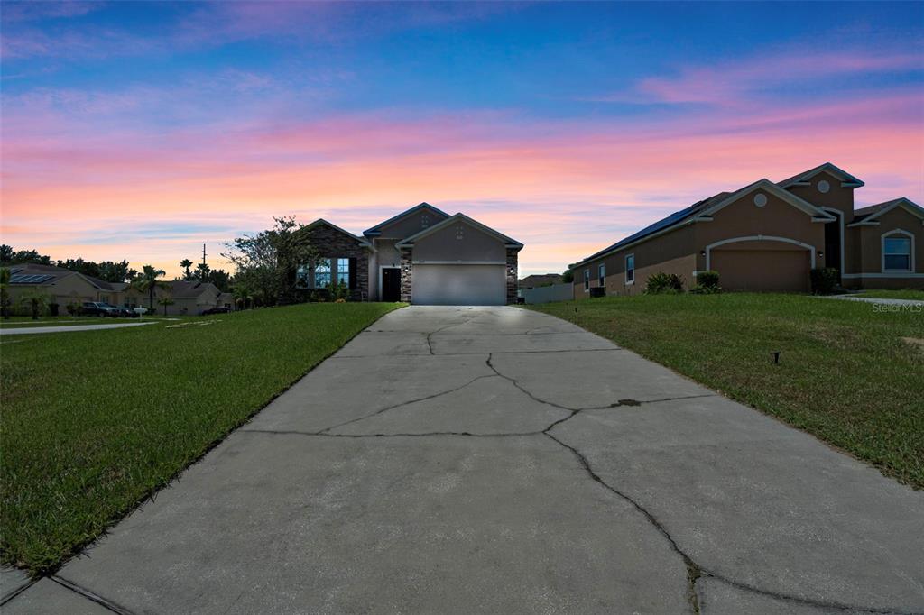 3509 Spring Creek Road Dundee, FL 33838 - Photo 31 of 32 a front view of a house with a yard and garage