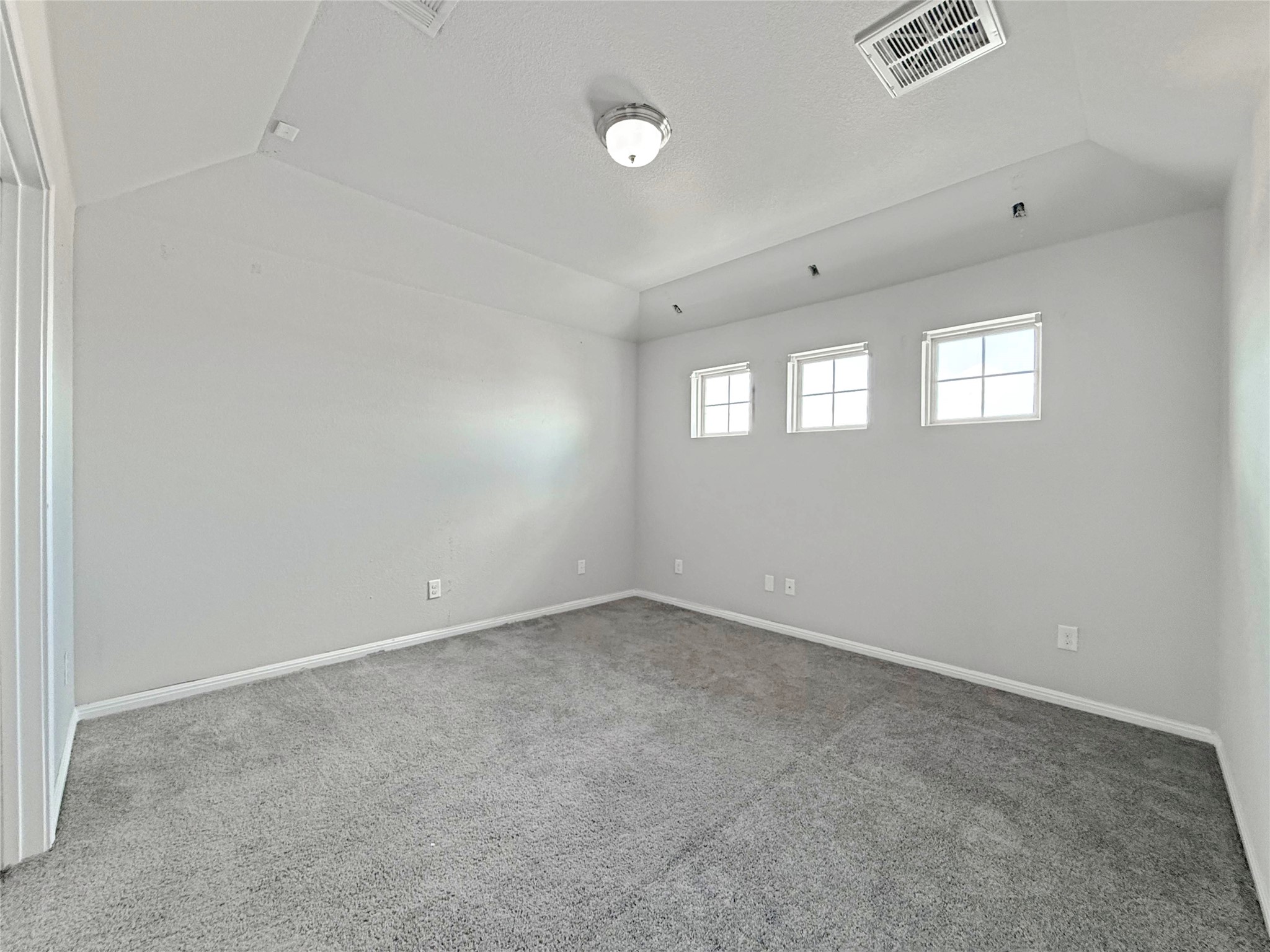 429 Rusk Bluff Avenue Leander, TX 78641 - Photo 14 of 24 A well-lit bedroom features plush carpeting and three bright windows.