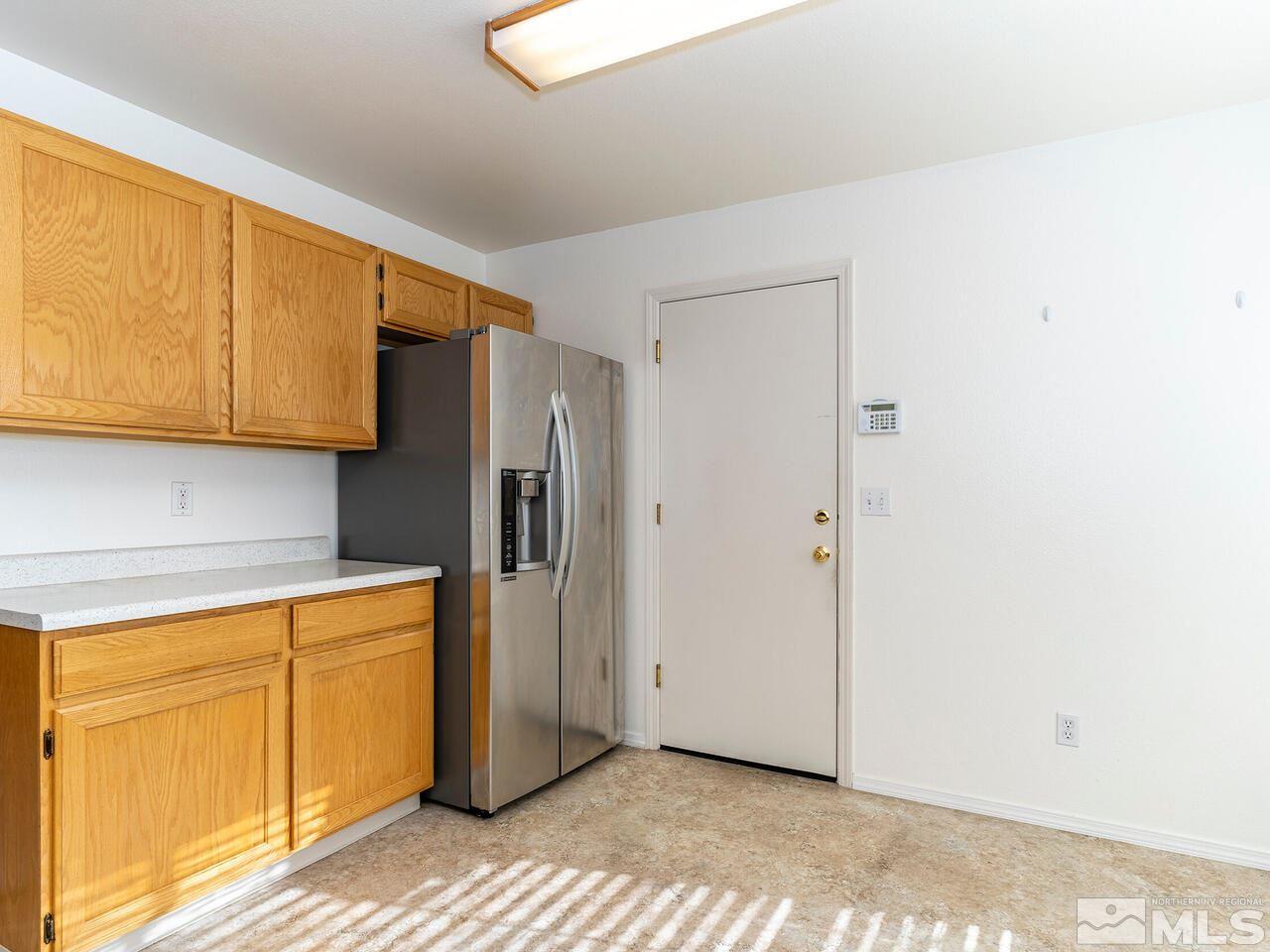 4765 Goodwin Road Sparks, NV 89436 - Photo 12 of 22 a kitchen with stainless steel appliances a refrigerator and cabinets