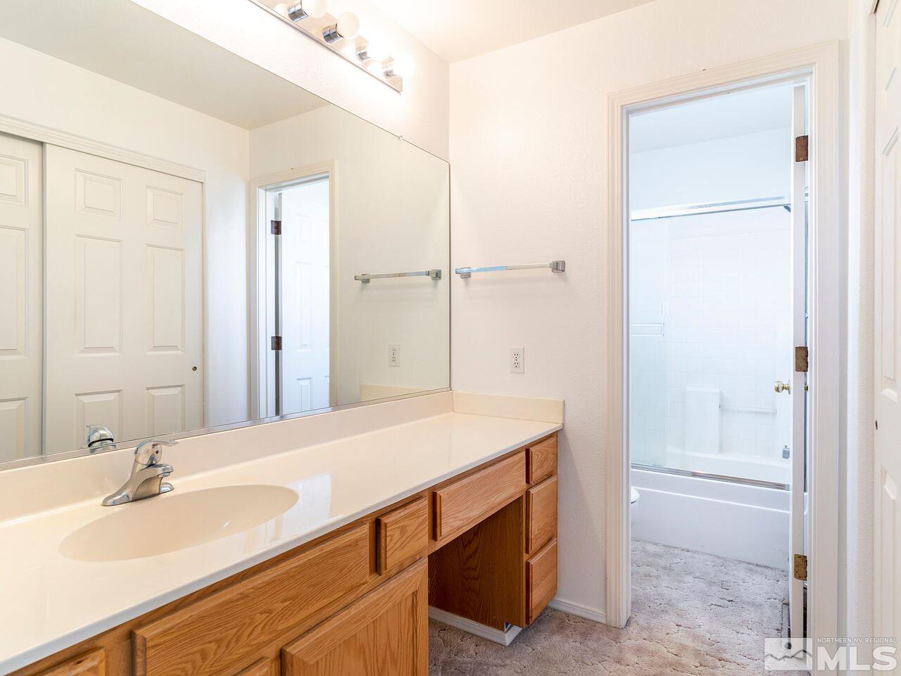 4765 Goodwin Road Sparks, NV 89436 - Photo 15 of 22 a bathroom with a sink and a mirror