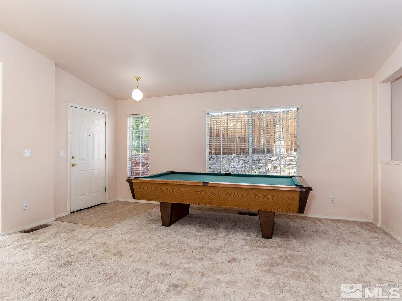 4765 Goodwin Road Sparks, NV 89436 - Photo 3 of 22 a room with pool table and windows