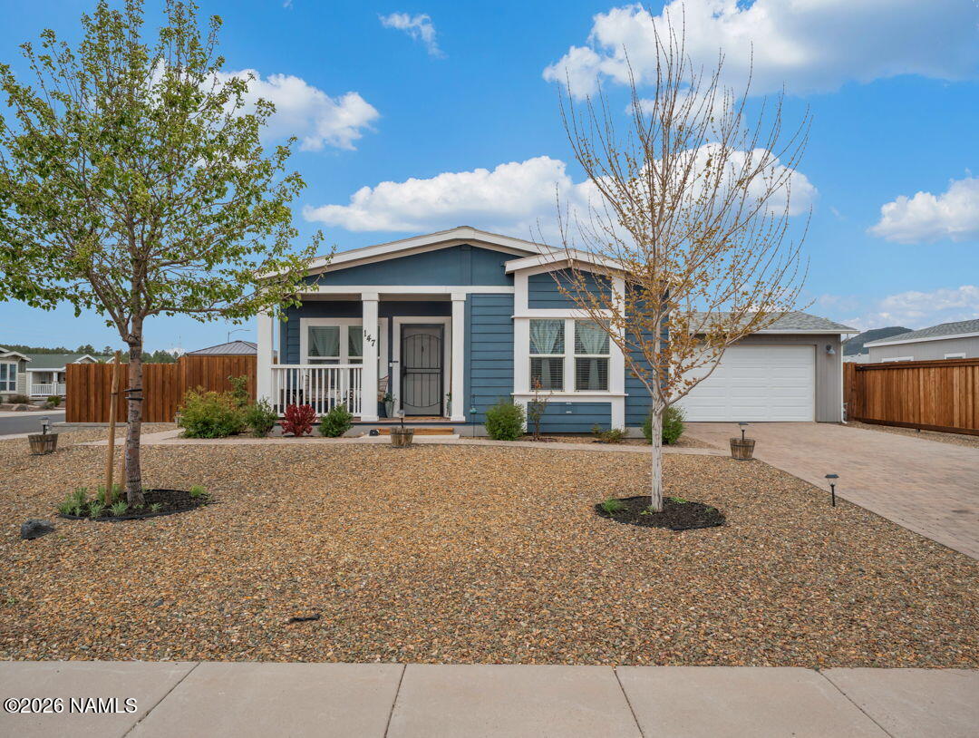 147 Pinecrest Trail Williams, AZ 86046 - Photo 3 of 39 a front view of a house with a yard and garage