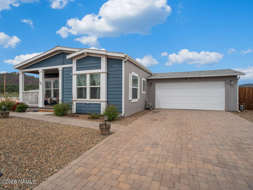 147 Pinecrest Trail Williams, AZ 86046 - Photo 36 of 39 a front view of a house with a yard and garage