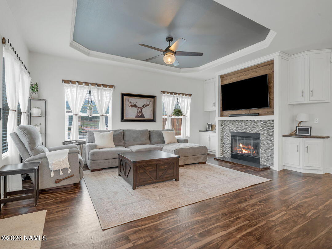 147 Pinecrest Trail Williams, AZ 86046 - Photo 10 of 39 a living room with furniture a flat screen tv and a fireplace