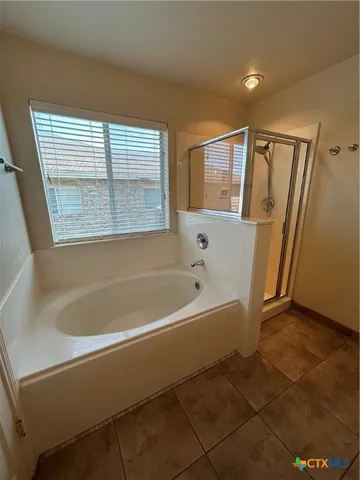 a white bath tub sitting next to a window