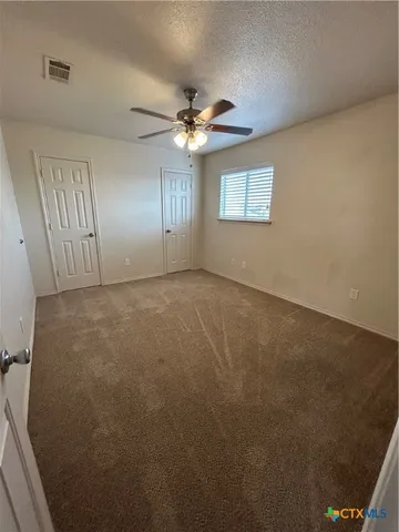 an empty room with a empty space and a ceiling fan