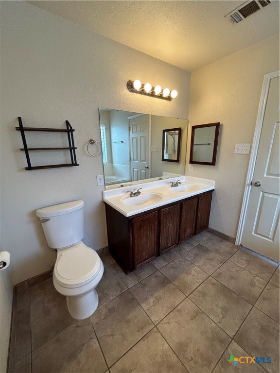 3043 Rain Dance Loop Harker Heights, TX 76548 - Photo 10 of 20 a spacious bathroom with a toilet a sink and mirror
