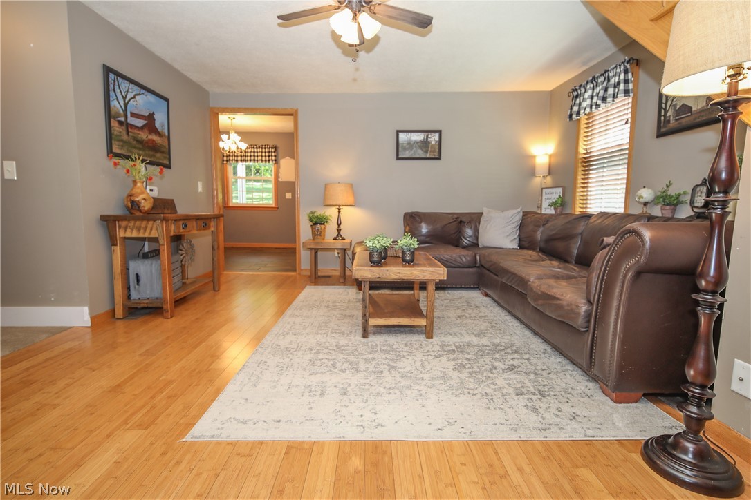 38610 Spiedel Town Road Bethesda, OH 43719 - Photo 15 of 33 Living room with ceiling fan with notable chandelier and light wood-type flooring