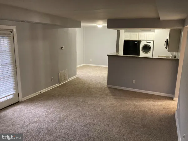 a view of a kitchen with stainless steel appliances