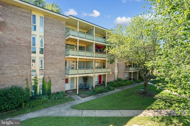 a front view of a building with a garden