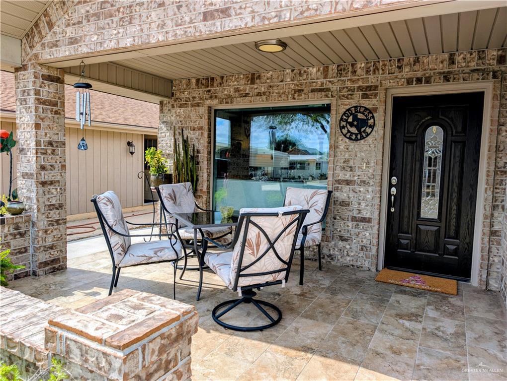 404 Jupiter Street Mission, TX 78572 - Photo 2 of 22 Entrance to property featuring a covered patio and outdoor dining area.