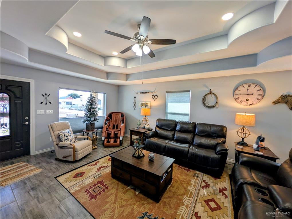 404 Jupiter Street Mission, TX 78572 - Photo 3 of 22 Living area with ceiling fan, wood-style tile floors, healthy amount of natural light, recessed lighting, and a trey ceiling