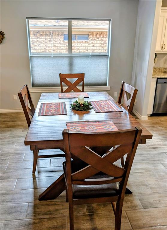 404 Jupiter Street Mission, TX 78572 - Photo 5 of 22 Dining area featuring wood-style tile flooring.