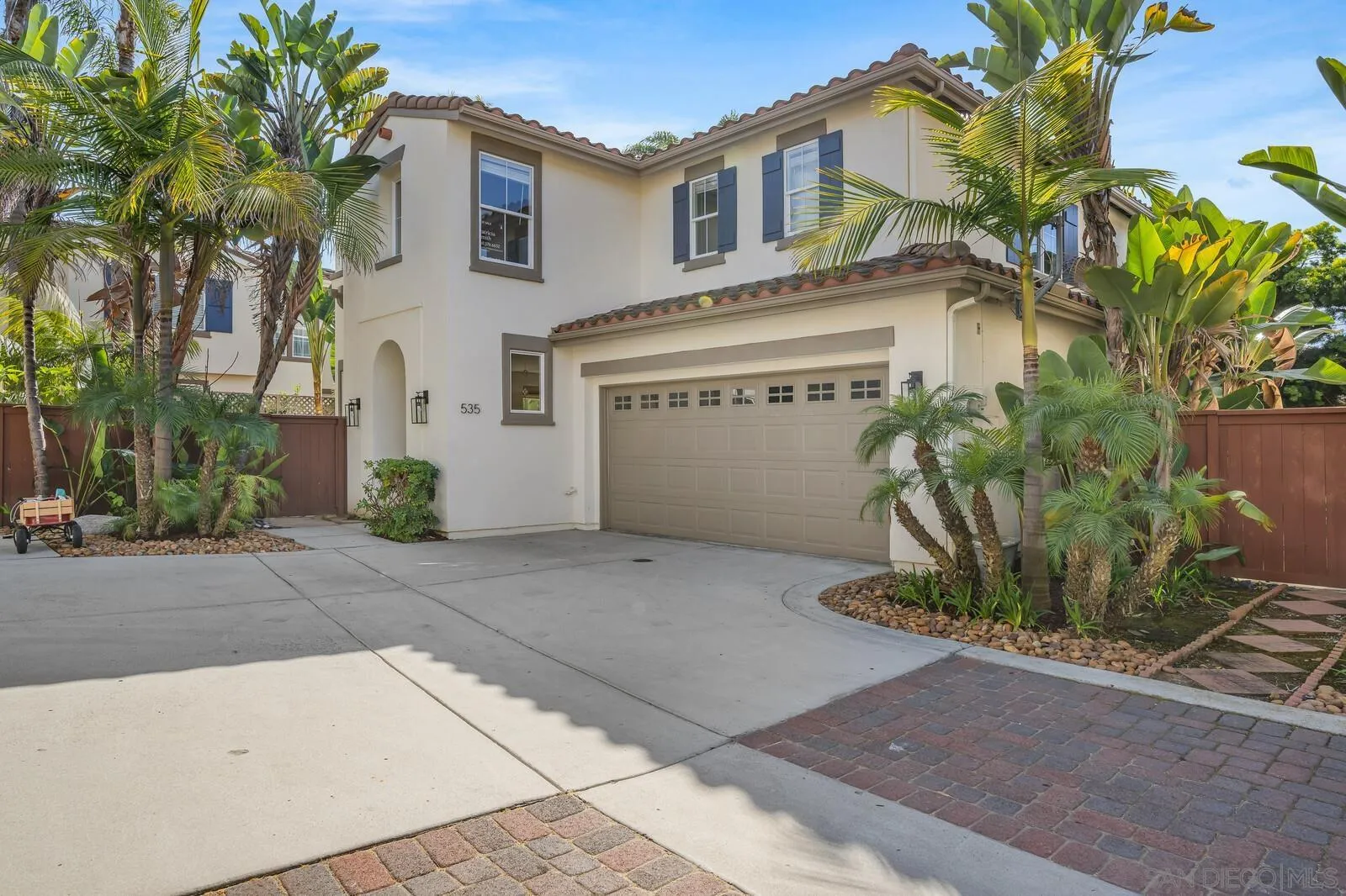 a front view of a house with a street