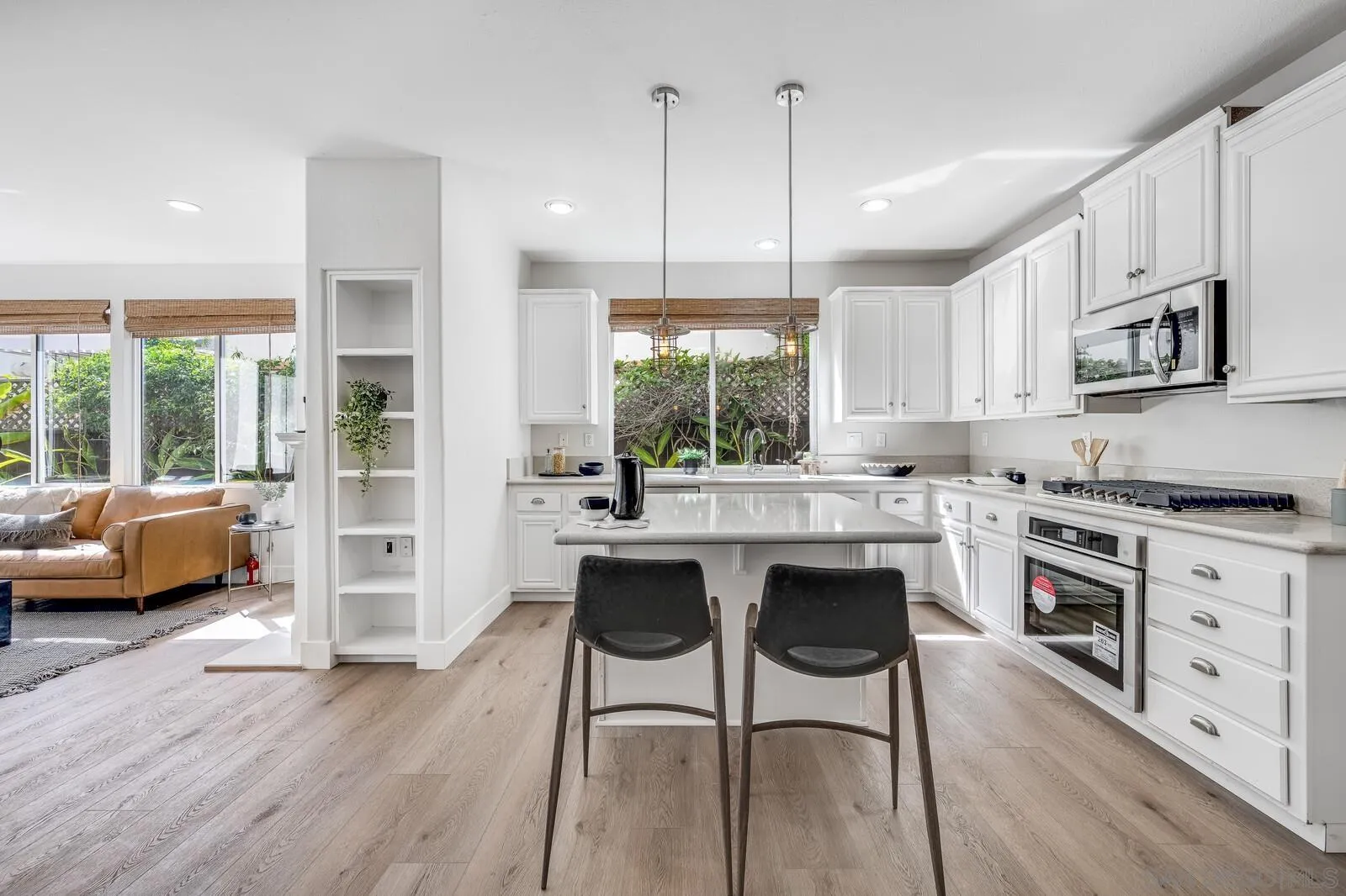 535 Anchorage Avenue Carlsbad, CA 92011 - Photo 13 of 36 a kitchen with stainless steel appliances granite countertop a stove top oven a sink dishwasher a dining table and chairs with wooden floor