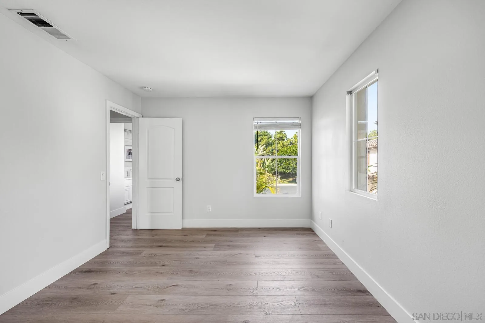 535 Anchorage Avenue Carlsbad, CA 92011 - Photo 31 of 36 an empty room with wooden floor and windows