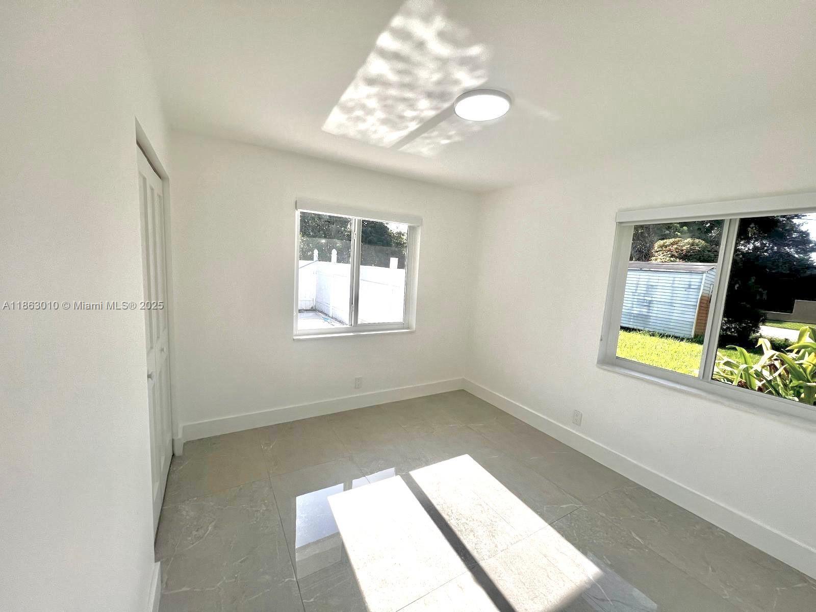 1590 Southwest 139th Avenue Davie, FL 33325 - Photo 11 of 20 a view of an empty room with a window