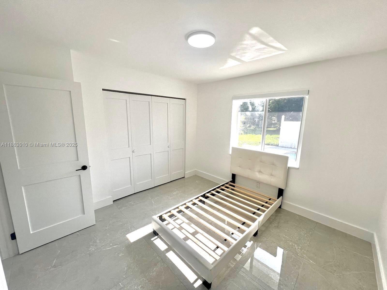 1590 Southwest 139th Avenue Davie, FL 33325 - Photo 12 of 20 an empty room with windows