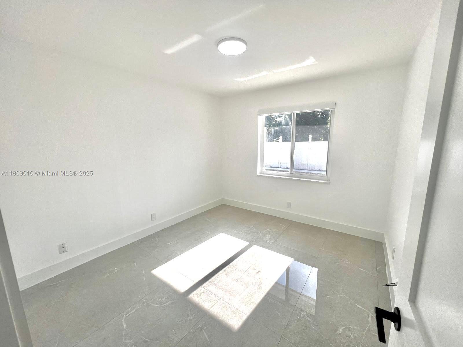 1590 Southwest 139th Avenue Davie, FL 33325 - Photo 13 of 20 an empty room with windows
