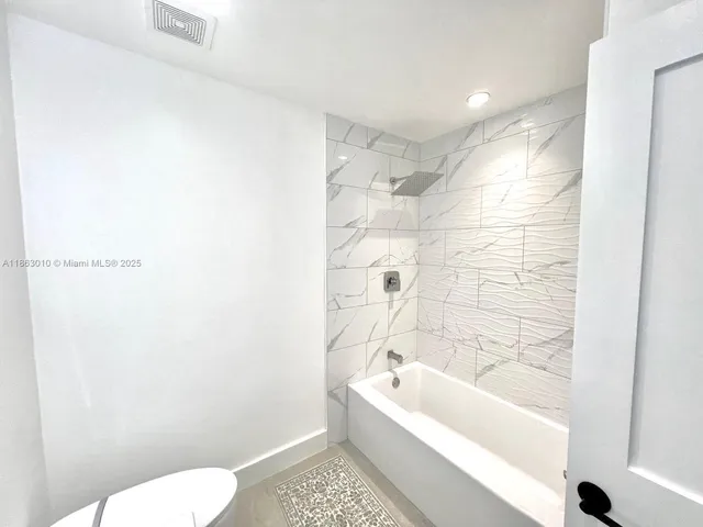 a bathroom with a bathtub and toilet