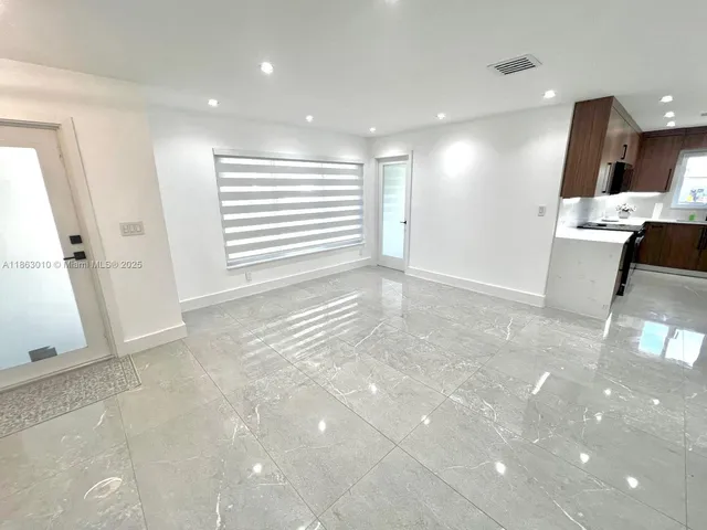 a view of a kitchen with a sink and cabinets