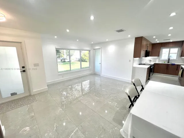 a view of livingroom and dining room with furniture