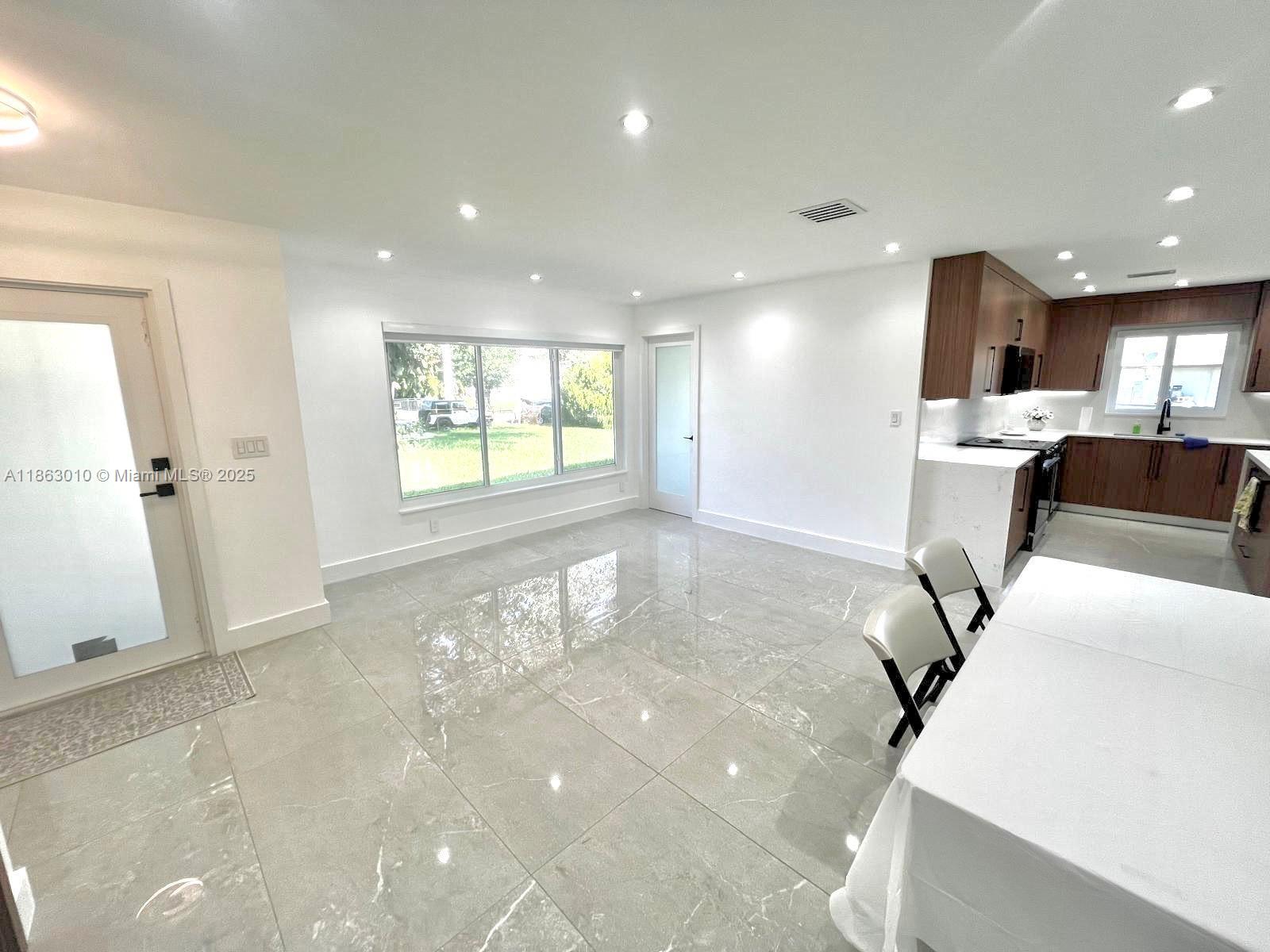 1590 Southwest 139th Avenue Davie, FL 33325 - Photo 6 of 20 a view of livingroom and dining room with furniture