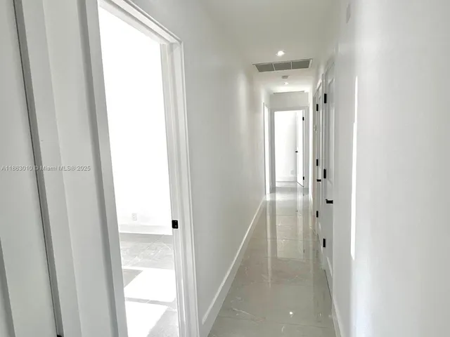 a view of a bathroom from the hallway