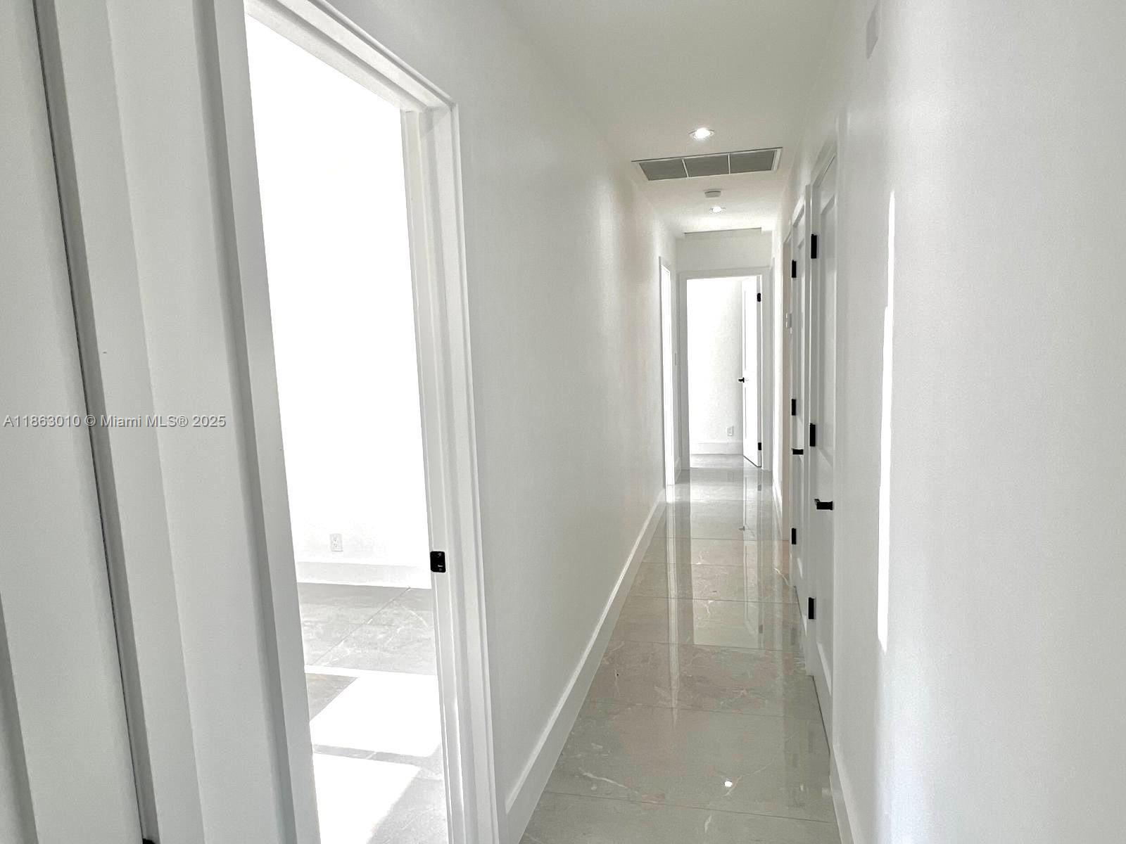 1590 Southwest 139th Avenue Davie, FL 33325 - Photo 7 of 20 a view of a bathroom from the hallway