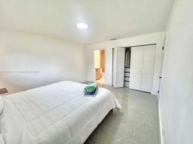 a bedroom with a bed and cabinets