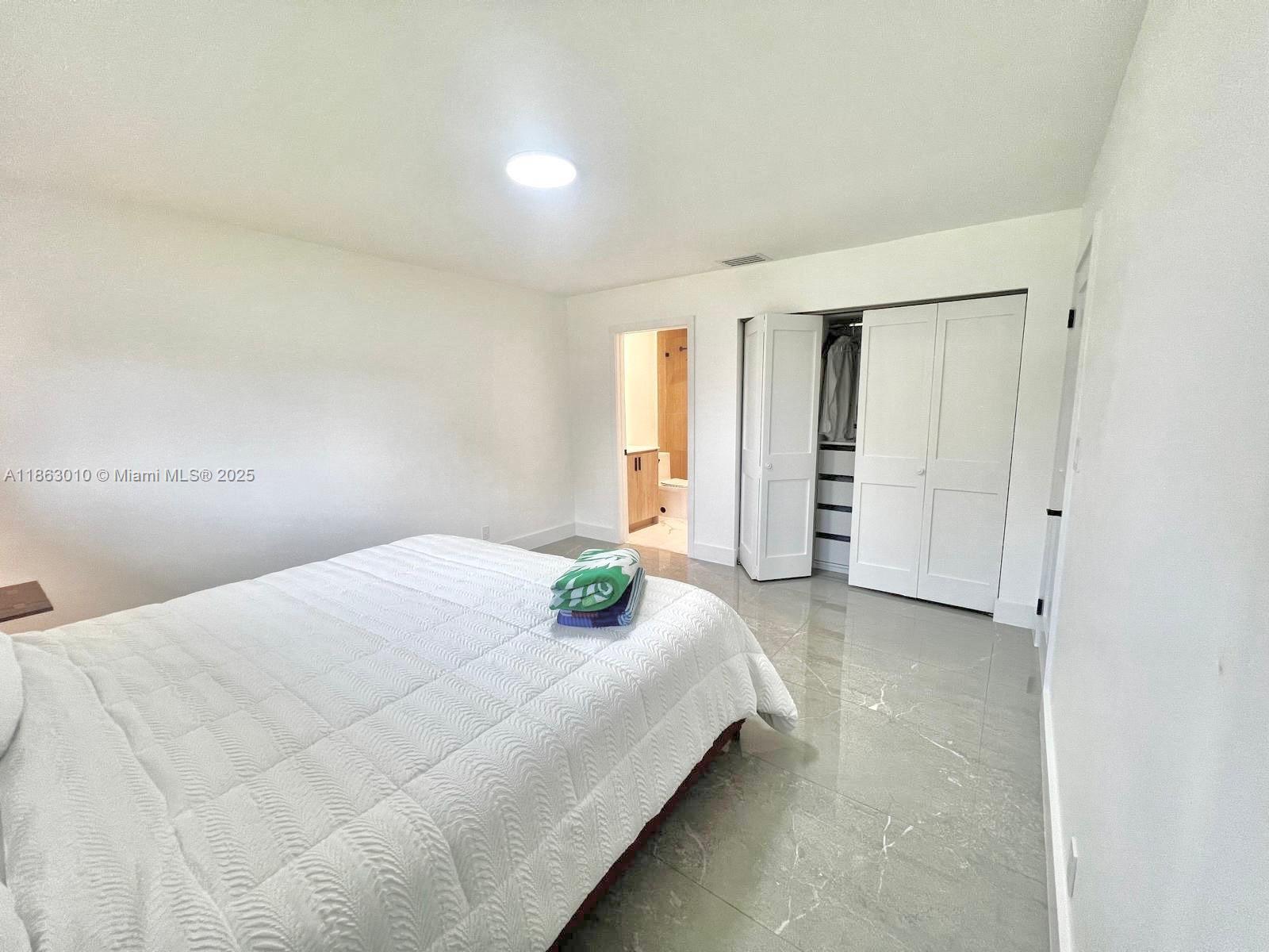 1590 Southwest 139th Avenue Davie, FL 33325 - Photo 9 of 20 a bedroom with a bed and cabinets