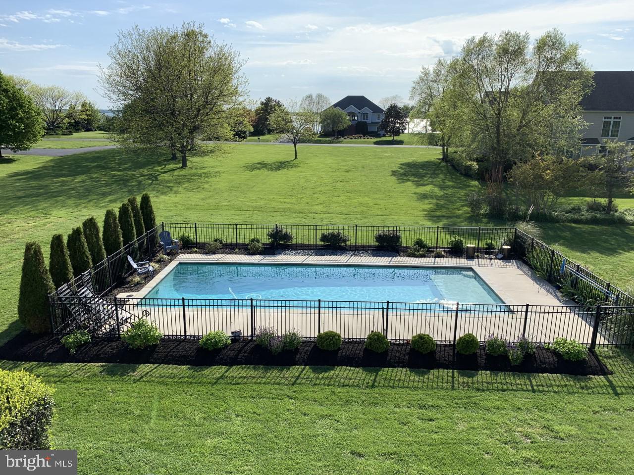 2902 Cox Neck Road East Chester, MD 21619 - Photo 2 of 57 a view of a swimming pool with lawn chairs and plants