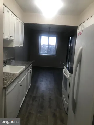 a kitchen with a sink a washer and dryer