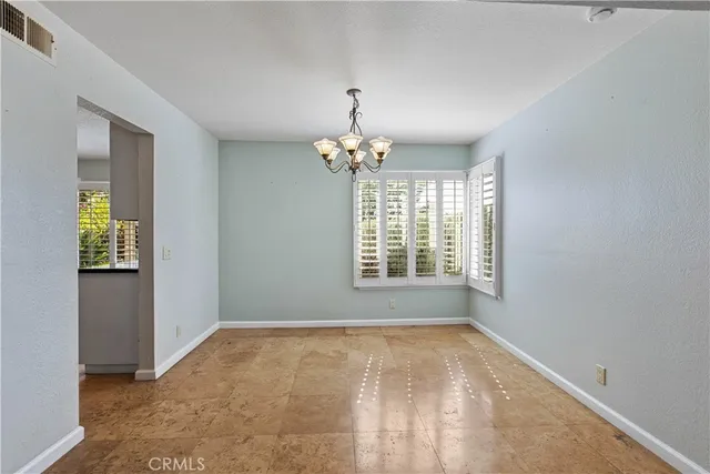 a kitchen with stainless steel appliances granite countertop a stove top oven a sink dishwasher a microwave oven and a refrigerator with wooden cabinets