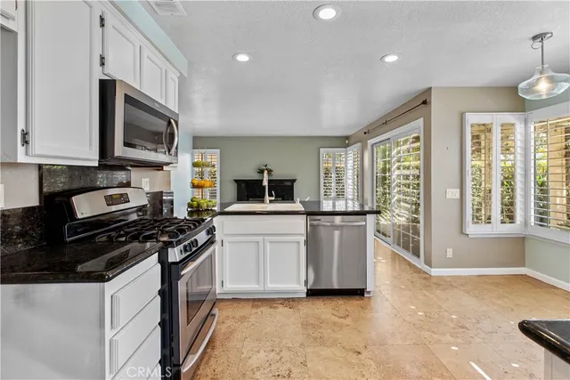 a kitchen with cabinets and appliances