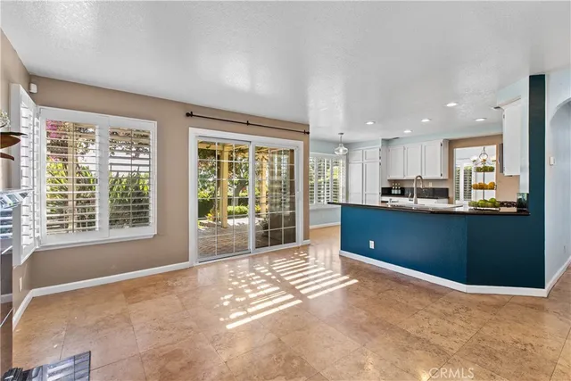 a view of kitchen with kitchen island and stainless steel appliances