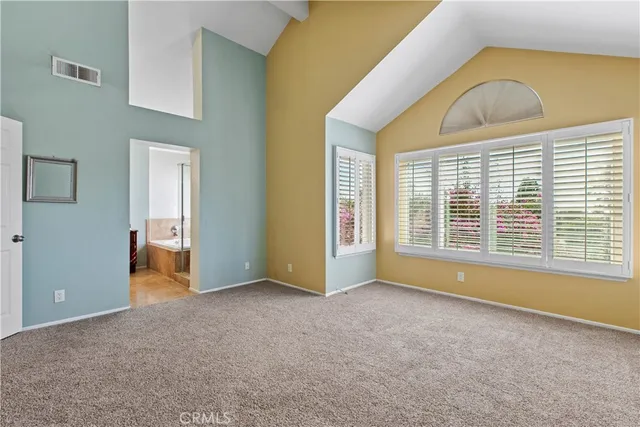 a bathroom with a granite countertop sink a large mirror and a bathtub