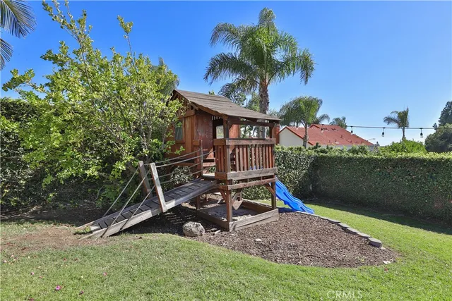 a backyard of a house with lots of green space and mountain view in back