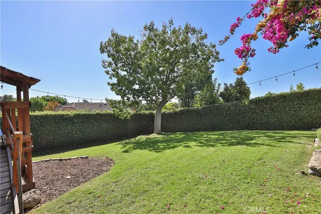 a view of a porch with a table and chairs and potted plants