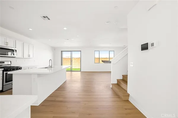 a view of a kitchen with microwave and cabinets