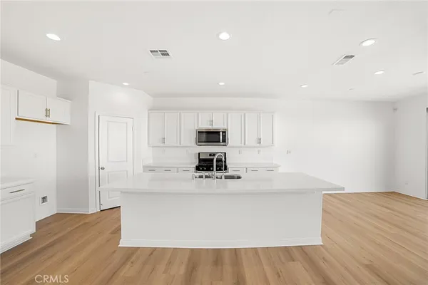 a view of kitchen with stainless steel appliances cabinets