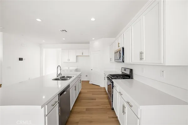 a kitchen with a sink stove and cabinets